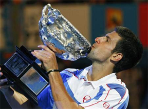 Novak Djokovic of Serbia holds his trophy after beating Andy Murray of Britain during their men’s singles final match at the Australian Open tennis tournament in Melbourne yesterday. REUTERS/Petar Kujundzic