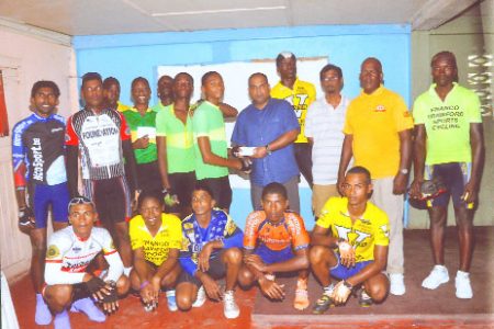 Sabha Tulshi (fifth right) presents the winning prize to Michael Anthony in the presence of participants of the Flying Ace Cycle Club’s second annual Dhansar Tulshi 40-mile cycle road race.