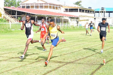 Samuel Doris (second left) crosses the finish line in the 400m under-18 race at the AAG Developmental meet at the Eve Leary ground yesterday. (Orlando Charles photo) 