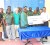 GT&T’s Chief Financial Officer Royston Rachpaul (second from right) hands over the replica cheque to Manager of the National Sevens Rugby team Robin Roberts in the presence of Union officials and the team yesterday. 