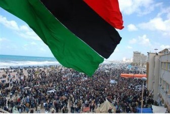 Protesters wave a flag in this undated picture made available on Facebook February 21, 2011. The image was purportedly taken recently in Benghazi. Reuters/Handout