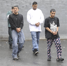 Vishan Parbhudial (left), Richard Baliraj (centre) and Dhanashar Persaud leave the lock-up at Schenectady yesterday after being charged with the Saturday killing of Ganesh Ramgoolam. (Times Union photo)
