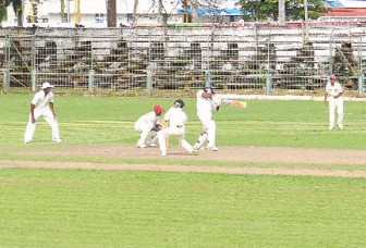 Gajanand Singh drives down the wicket during his unbeaten half century yesterday at the GCC ground. (Orlando Charles photo)  