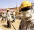 A Chinese engineer covers his face from dust at a construction site in Sudan's capital Khartoum, February 16, 2009. REUTERS/Mohamed Nureldin Abdallah