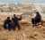 Rebel fighters sit at their position in Bin Jawad yesterday. (REUTERS/ Goran Tomasevic)