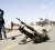 A rebel fighter fires his rifle at a military aircraft loyal to Libyan leader Muammar Gaddafi at a checkpoint in Ras Lanuf March 7, 2011. (Reuters/Goran Tomasevic )