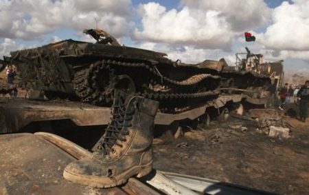 A boot belonging to a soldier loyal to Libyan leader Muammar Gaddafi is seen on a destroyed tank after an air strike by coalition forces, along a road between Benghazi and Ajdabiyah March 21, 2011. (Reuters/Suhaib Salem)