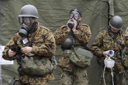 Japan Self-Defense Force officers prepare for a clean-up at a radiation affected area in Nihonmatsu, Fukushima Prefecture in northern Japan, March 15, 2011. 