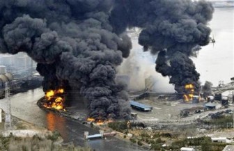 A factory facility burns following an earthquake and tsunami in Sendai, northeastern Japan March 12, 2011. REUTERS/Kyodo