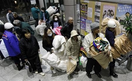 Evacuees hold blankets as they stand in a line to enter a temporary shelter after radiation leaked from an earthquake-damaged Fukushima nuclear reactor, in Koriyama, northeastern Japan March 12, 2011. REUTERS/Jo Yong-Hak