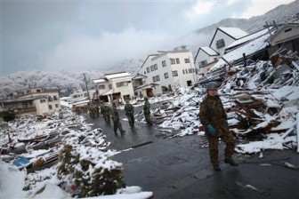 Members of the Japan Self Defence force walk through the snow-covered ruins of Kamaishi, Iwate Prefecture, days after the area was devastated by a magnitude 9.0 earthquake and tsunami March 16, 2011. REUTERS/Damir Sagolj