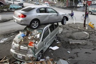 A car sits atop another in an area affected by an earthquake and tsunami in Miyako, Iwate prefecture March 14, 2011. REUTERS/Aly Song