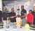 Guinness Brand Manager Lee Baptiste (third right) hands over the first prize trophy to tournament organizer Sharma Solomon while fellow organizer Caeron Sealey (left), Banks DIH PRO Troy Peters (second left), Linden Branch Manager Shondell Eastman, second right and Banks DIH Sales and Marketing Manger Carlton Joao look on. (Orlando Charles Photo) 