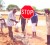 Region 9 Road Safety Council Chairman Terrence Boston (with bucket) and a constable of the police traffic department in Lethem erect a stop sign with the help of volunteers. 