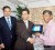 Minister of Education, Shaik Baksh, on behalf of the Ministry receiving one of the Acer Notebook computers from Alan Zakir. At left is Chris Sammy. 