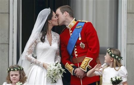 Prince William and his wife Catherine, Duchess of Cambridge, kiss as they stand on the balcony at Buckingham Palace today .  REUTERS/Darren Staples