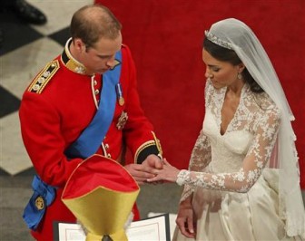 Prince William and Kate Middleton exchange rings before the Archbishop of Canterbury, Rowan Williams, during their wedding ceremony In Westminster Abbey, in central London April 29, 2011. REUTERS/Andrew Milligan/Pool