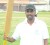 Hemendra Kowlessar raises his bat after a well played innings of 49 runs.