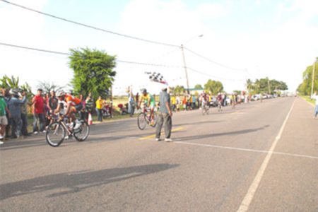 Yosmani Pol crossed the line ahead of Warren ‘Forty’ Mc Kay yesterday for the National Sports Commission Three-stage race.   
