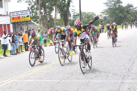Guyana’s Godfrey Pollydore (right) celebrates upon finishing first in the final stage of the Three-stage Road Race ahead of Warren Mc Kay (centre) and Yosimi Pol (left). (Orlando Charles Photo)