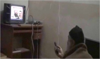 Osama bin Laden watching video in the compound (US Department of Defence)