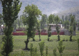 Surrounded in red fabric, a compound is seen where locals reported a firefight took place overnight in Abbotabad, located in Pakistan's Khyber Pakhtunkhwa province, May 2, 2011. REUTERS/Abrar Tanoli