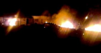 The compound, within which al Qaeda leader Osama bin Laden was killed, is seen in flames after it was attacked in Abbottabad in this still image taken from video footage from a mobile phone May 2, 2011. REUTERS/Stringer