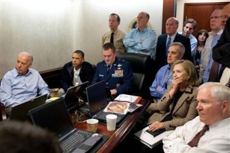 President Barack Obama (2nd L) and Vice President Joe Biden (L), along with members of the national security team, receive an update on the mission against Osama bin Laden in the Situation Room of the White House, May 1, 2011. Also pictured are Secretary of State Hillary Clinton (2nd R) and Defense Secretary Robert Gates (R). Please note: A classified document seen in this photograph has been obscured at source. REUTERS/White House/Pete Souza/Handout