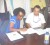 Dr Lystra Fletcher-Paul, FAO’s representative to Guyana (left) signs the agreement, while Toshao of Muritaro Village Lester Fleming looks on. The village is one of the beneficiaries of the training.