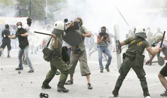 Demonstrators and riot police clash during anti-austerity protests in Athens yesterday. REUTERS/Panagiotis Tzamaros