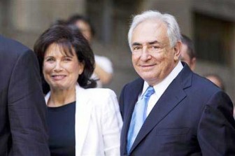 Former IMF chief Dominique Strauss-Kahn smiles as he and his wife Anne Sinclair depart a hearing at the New York State Supreme Courthouse in New York yesterday.  REUTERS/Lucas Jackson