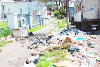 This unholy mess is a regular sight near the gates of the St. Barnabas Church, which has now been sold. (Stabroek News file photo)