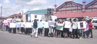 More than 20 relatives and friends of Homestretch Avenue accident victim, Peter Mc Lennon yesterday protested outside the Ministry of Home Affairs on Brickdam, the Stabroek Market square and the Sophia bus park in front of Demico.  The protesters urged drivers to stop speeding on the roadways, to stop drinking and driving, and for commuters to take matters in their own hands and “speak up or get out” of the vehicles when drivers are speeding or have their music on too loud.  On Monday, five persons died when a speeding minibus suffered a tyre blowout and toppled. Several other persons remain hospitalized. 