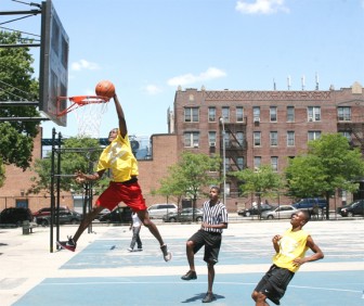 Ashford Johnson slams his way to the MVP of the game while also in photo is Georgetown shooting guard, Tristan Lake. 