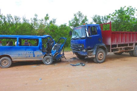 Head on collision: Minibus BKK 5112 and the truck GNN 2507, which collided yesterday morning at Nottinghamshire, Old England, Linden killing two-year-old Malvin Hartman, of Coomacka Mines, Linden and injuring 11 others, including members of his family. (Photo by Cathy Richards) 