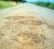 Potholes in the newly renovated road leading to the airstrip. 
