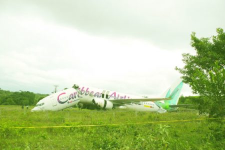 Broken: BW 523, Caribbean Airlines Boeing 737-800 series aircraft, bearing registration 9Y-PBM lies broken at the Cheddi Jagan International Airport yesterday. The US$38 million aircraft was acquired in 2007. (Photo by Aubrey Crawford)