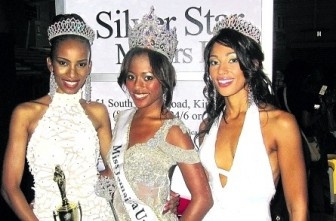 Newly-crowned Miss Jamaica Universe 2011, Shakira Martin, is flanked by her runners-up Kadyan Salmon (left) and Chantal Zacky, at the National Indoor Sports Centre in Kingston early Sunday morning. (Jamaica Observer photo)