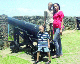 Vonetta Haynes-Reyes, 31, and her sons, Malik, eight, and Makasi, four, at a fort in a photo from the family album. (Trinidad Express photo)