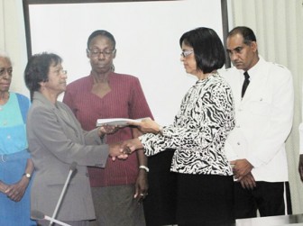 Chairperson of the Women and Gender Equality Commission, Indranie Chandarpal handing over the Commission’s first periodic report to Deputy Speaker of the House, Clarissa Riehl. (GINA photo)