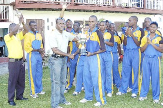 Rawle Lewis presents the 2011 West Indies Cricket Board under-19 limited overs trophy to Barbados skipper Kraigg  Brathwaite . (Orlando Charles photo)