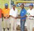 Kester Abrams, Courts Guyana Inc. Marketing Assistant (second right) presents the winner’s trophy to Patrick Prashad while President of Lusignan Golf Club Brian Hackett (left), Rawle Moore and Fazil Haniff look on.