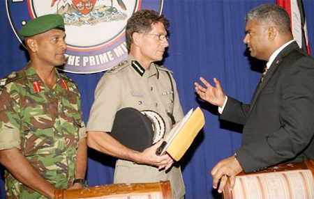 Attorney General Anand Ramlogan, right, talks with Police Commissioner Dwayne Gibbs, centre, and Chief of Defence Staff Brigadier Kenrick Maraj at the national security briefing and post-Cabinet news conference at the Diplomatic Centre, St Clair, yesterday. (Trinidad Guardian photo) 