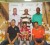 Champion Mike Mangal (seated centre) flanked by Demerara Distillers Ltd., representatives  Jeranzee Marques (left) and Mark Chinapen (right) Standing are William Walker Muntaz Haniff and Brian Hackett (President of LGC).