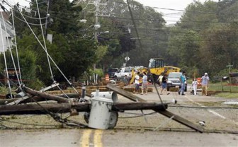 Residents inspect fallen power lines in Hampton Bays, New York yesterday. Hurricane Irene battered New York. REUTERS/Lucas Jackson  