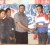  Vice-Captain of the Pepsi Under-19 team Loyydel Lewis accepts the sponsorship cheque from DDL Branch Manager, Albert Budhoo, in the presence of company representatives and team members.