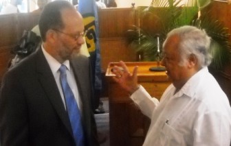 Newly-appointed  Caricom Secretary-General Irwin  LaRocque (left) being greeted by  former Commonwealth Secretary-General Sir Shridath  Ramphal .