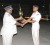Sergeant Melville (right) last evening collecting the winner’s trophy from Police Commissioner Henry Greene. Melville who was promoted to Corporal was also adjudged the best drill instructor for which he received a cash award.