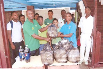 Coach Renwick Batson hands over the lunches to the Canaan Children Home.