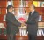 Justice Carl Singh (right) hands over one of the volumes to President of the Guyana Association of Legal Practitioners, Ramesh Rajkumar.